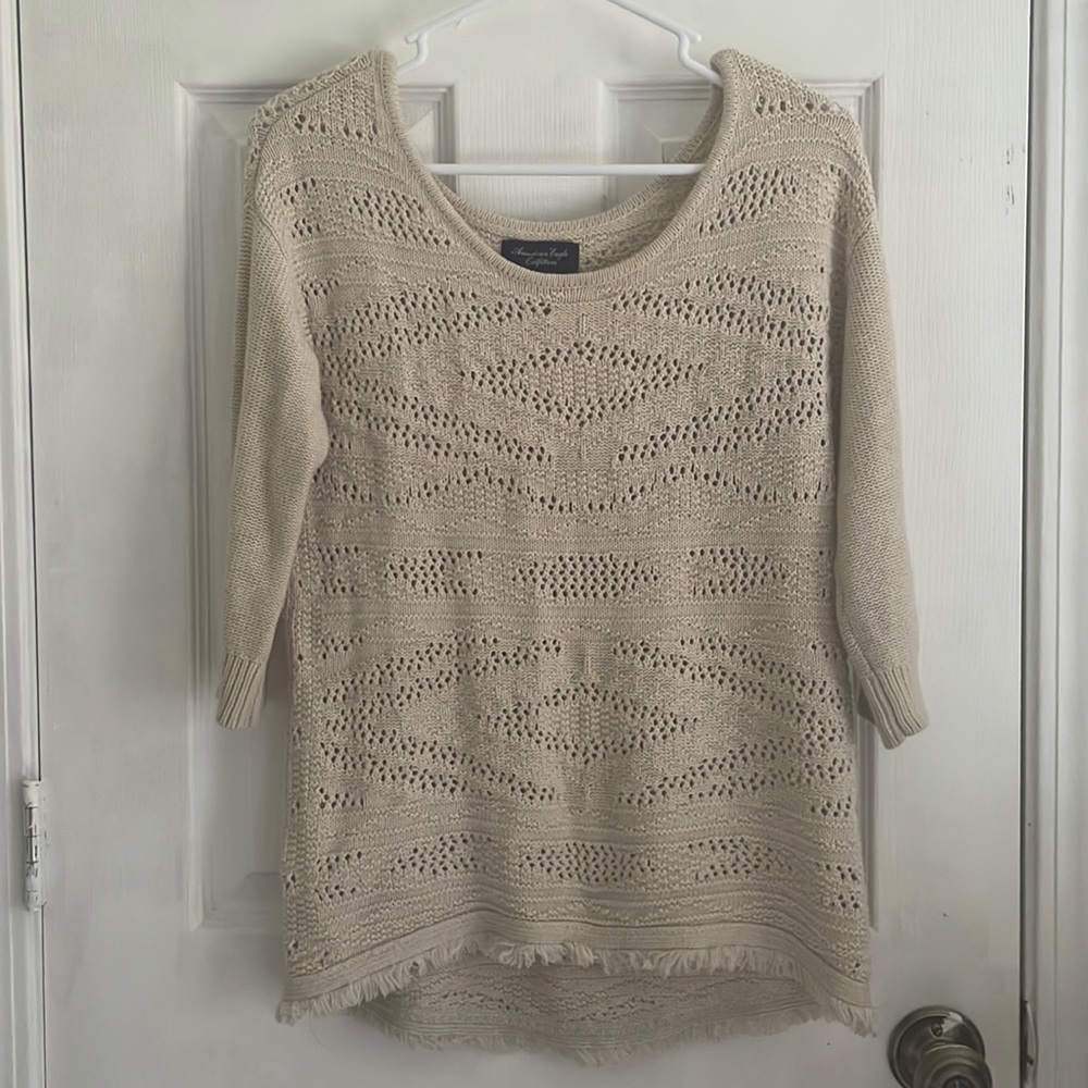 Tan crochet-detail sweater with quarter-length sleeves